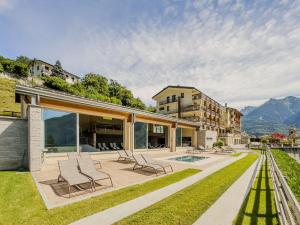 a house with a patio with chairs on it at Belvedere Hotel in Crodo
