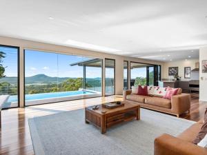 a living room with a couch and a table at Wilderness House in Kulangoor