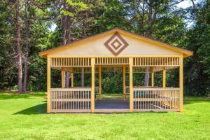 a small yellow gazebo in a field of grass at Days Inn by Wyndham Shelby in Shelby