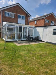 an extension to a house with a patio at New Forest holiday Home in Hythe