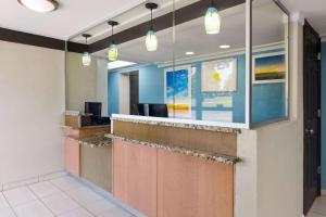 a lobby of a hospital with a reception counter at Day's Inn & Suites by Wyndham Indianapolis Airport East in Indianapolis