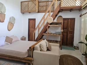 a bedroom with a bed and a staircase at Memo's Beach in Nilaveli