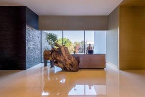 a room with a table and a tree stump at Hyatt Regency Andares Guadalajara in Guadalajara