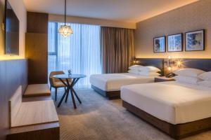 a hotel room with two beds and a table at Hyatt Regency Andares Guadalajara in Guadalajara