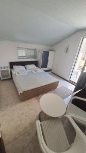 a bedroom with a bed and a table and chairs at Vojinovic Apartments in Budva