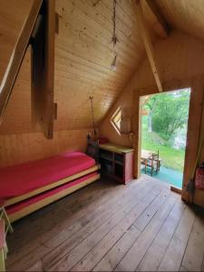 a room with a bed and a desk in a cabin at Cabane insolite in Saint-Victor-de-Morestel