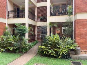 a building with plants in front of it at Castle Apartments Kampala 2 in Kampala