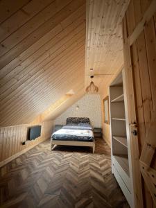 a bedroom with a bed and a wooden ceiling at Sielski Zaułek Guciów u Dorotki -Basen,Jacuzzi,Sauna in Guciów +42 photos