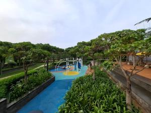 a water park with a slide and a playground at New! 1 bedroom Gold coast Pik Honolulu tower in Jakarta