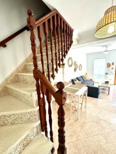 a staircase in a living room with a couch and a table at Vistas del Valle in Valle de Abdalagís