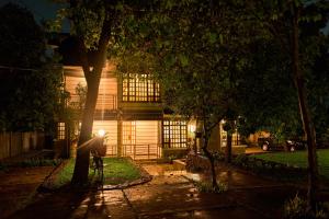 a person standing in front of a house at night at Gavril's Bed and Breakfast in Arusha
