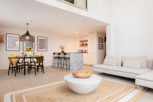 a living room with a white couch and a table at Seaside Loft Mano Jura 3 in Palanga