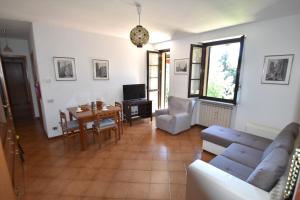 a living room with a couch and a table at Appartamento Isola Dei Fiori by Holidays LM in Luino