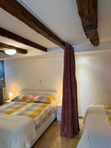 a bedroom with two twin beds and a curtain at Bernarda in Skrbčići