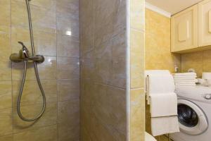a bathroom with a shower and a washing machine at Bernarda in Skrbčići +28 photos