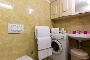 a bathroom with a washing machine and a sink at Bernarda in Skrbčići