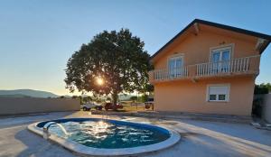 a house with a swimming pool in front of a house at Vila za odmor Svitavac in Trebinje
