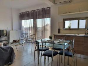 a dining room with a glass table and chairs at Iriana's Apartments in Center in Chania Town