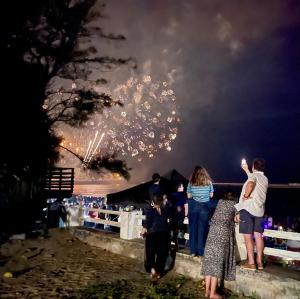 a group of people standing on a wall watching fireworks at Appartement entier Saint Pierre Centre dans résidence de prestige in Saint-Pierre