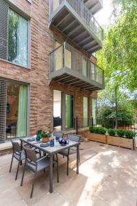 a patio with a table and chairs in front of a building at Atlas House Three in Harrogate