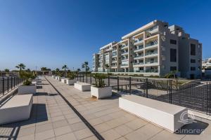 a building with benches in front of a building at Los Camaleones EXCELLENT & SOLMARES in Isla Canela