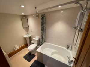 a bathroom with a tub and a toilet and a sink at Yairbrig Holiday in Galashiels +31 photos