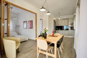 a dining room and living room with a table and chairs at Villa del Capitano in Corfu Town +31 photos