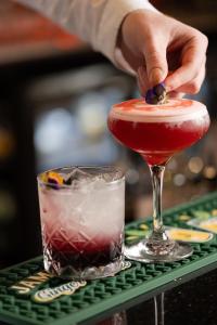 a person is adding a drink to a martini glass at The Villa Rose Hotel & V-Spa in Ballybofey +47 photos