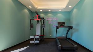 a gym with a treadmill and a sign that says dream pink at VacationClub Apartamenty Zakopiańskie Apartament 250 in Zakopane
