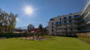 a park with a playground in front of a building at VacationClub Apartamenty Zakopiańskie Apartament 250 in Zakopane
