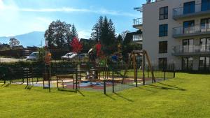 a playground in a yard next to a building at VacationClub Apartamenty Zakopiańskie Apartament 250 in Zakopane +15 photos