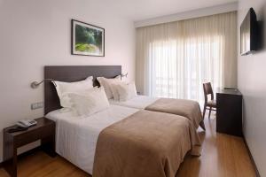 Postel nebo postele na pokoji v ubytování Hotel Miramar - São Pedro de Moel