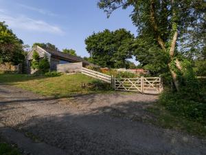a wooden fence in front of a house at Black Cat Bach in Abergavenny