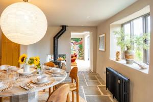 a dining room with a table and chairs at Monarc House by Big Skies Cottages in Baconsthorpe