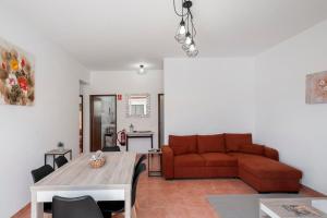 a living room with a couch and a table at Abelisa by An Island Apart in Porto Santo