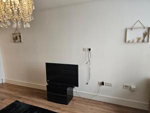 a living room with a flat screen tv on a wall at Close to Maidstone City Centre in Kent
