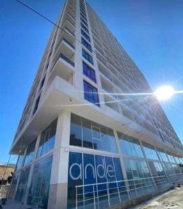 a tall building with a sign on the side of it at Moriya in Batumi
