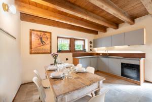 a kitchen and dining room with a wooden table and chairs at Baita Croh - Villaggio dei Crodini in Crodo