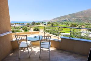 a balcony with two chairs and a table with a view at Sole Luna Hotel in Borsh