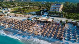 an aerial view of a beach with umbrellas and the ocean at Sole Luna Hotel in Borsh