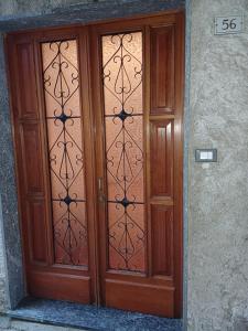 a wooden door with glass panels on a building at La casa sotto al volto in Licciana Nardi +2 photos