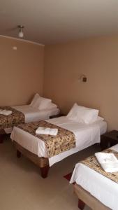 Кровать или кровати в номере Amaru Hotel