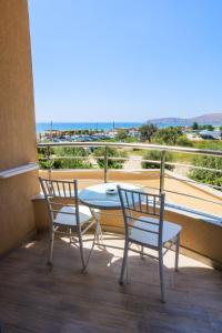 two chairs and a table on a balcony with a view at Sole Luna Hotel in Borsh