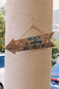 a sign that says beach is calling and i must go at Sole Luna Hotel in Borsh