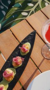 three deviled eggs on a black plate on a table at Infinity Resort Tropea in Parghelia