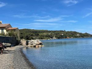 a view of a body of water with a house at Casa Grande Relais in Portoferraio