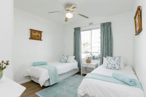a bedroom with two beds and a window at Laguna La Crete 88 in Uvongo Beach +18 photos