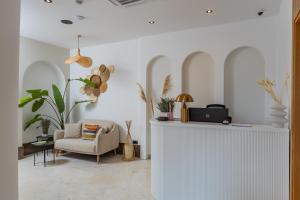 a living room with a chair and a table at Hotel AQUILO in Petrovac na Moru