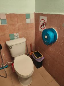 a bathroom with a toilet and a blue trash can at Spacious Studio with Private kitchen near Skytrain in Bangkok