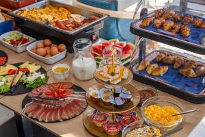 a buffet with many different types of food on a table at Hotel AQUILO in Petrovac na Moru